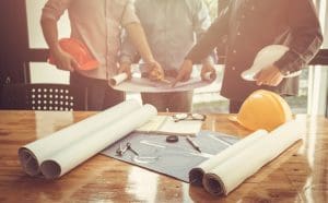Construction Workers with blueprints - Ascent Capital - Real Estate Funding Solutions