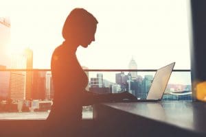 Woman working on a laptop - Ascent Capital - Real Estate Funding Solutions